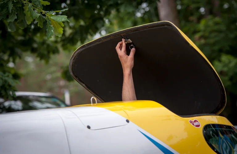 Uczestnik unosi rękę w górę, siedząc w łodzi motorowodnej po zakończonym przejeździe wzdłuż akwenu.