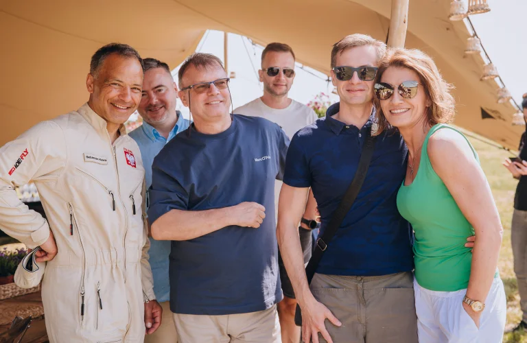 Event z serii Piąty Żywioł Powietrze z Sebastianem Kawą pozującym z grupą uczestników przed namiotem eventowym.